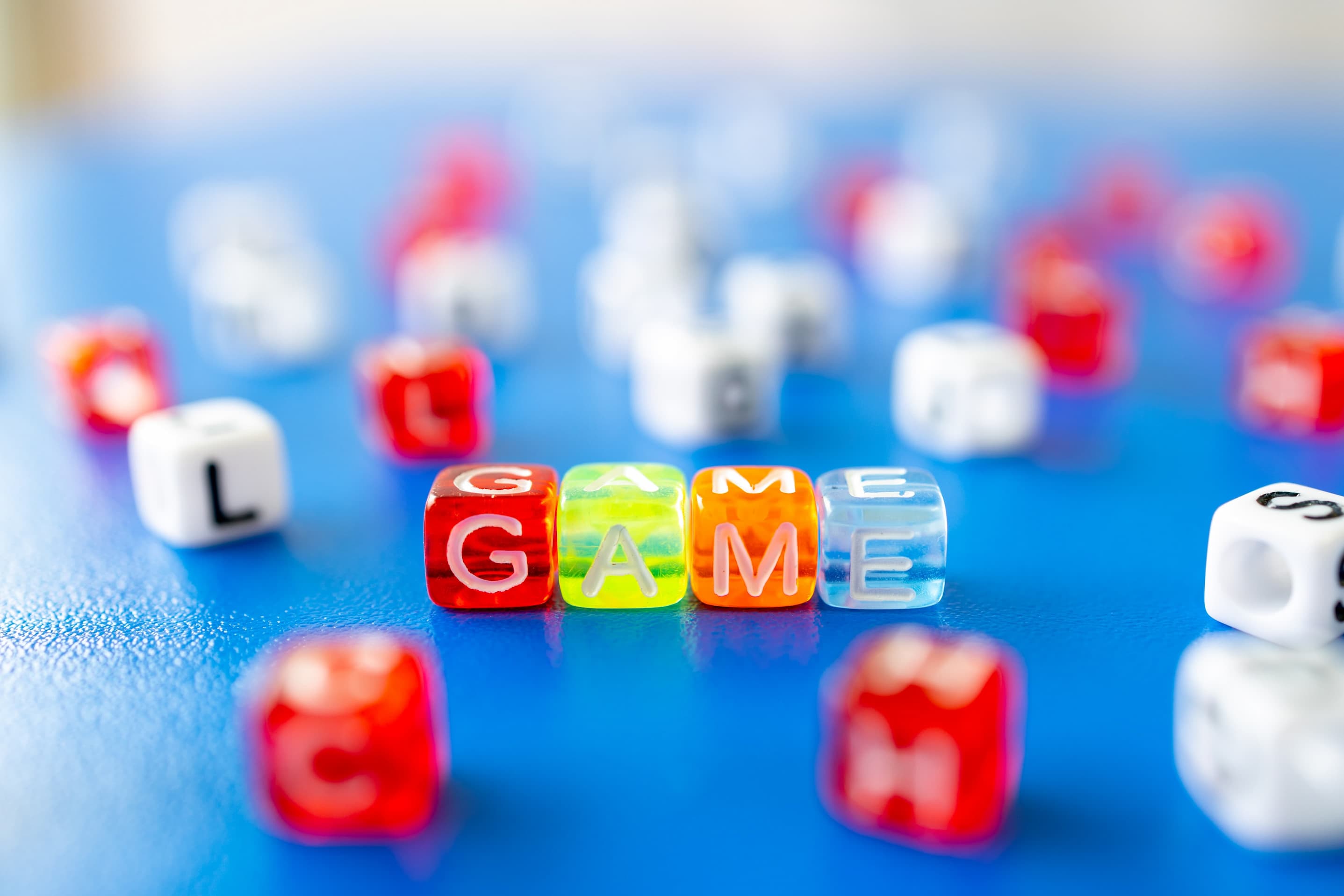 dice that spell out 'game' surrounded by scattered dice